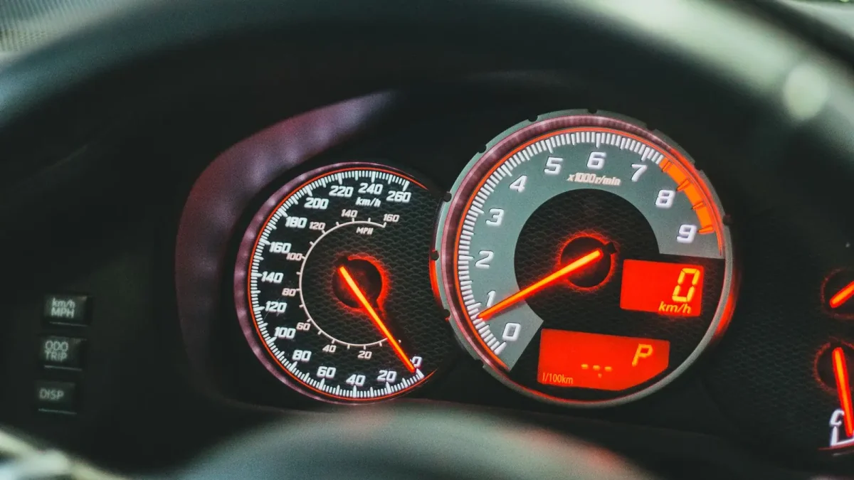 Car dashboard close-up showing the speedometer and odometer gauges
