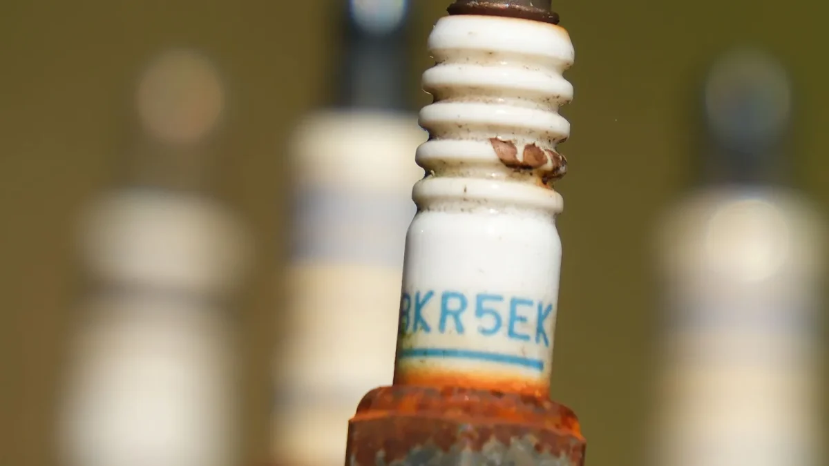 Close-up of a worn spark plug, a common cause of the P0300 random misfire code